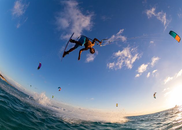 Low Angle Shot Person Surfing Flying Parachute Same Time Kitesurfing