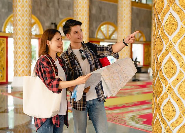 Happy Asian Couple Tourist Backpackers Holding Paper Map Looking Direction while Traveling Thai Temple Holidays Thailand Handsome Man Pointing Checking Map