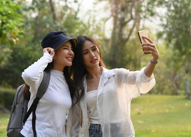 Asian College Woman Using Smart Phone Taking Selfie Together Campus