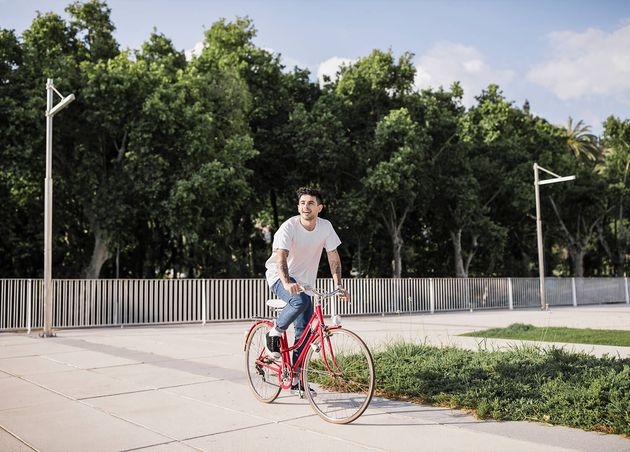 Young Man Riding Bike Park