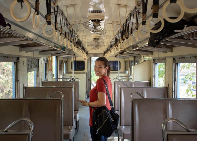 Asian Backpacker inside Public Train with Empty Seats Vacation