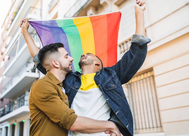 Portrait Young Gay Couple Embracing Showing Their Love with Rainbow Flag Street Lgbt Love Concept