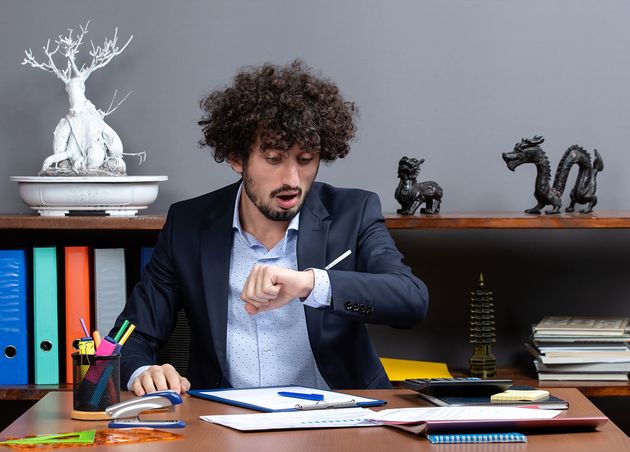 Front View Young Businessman Sitting Desk Checking Time