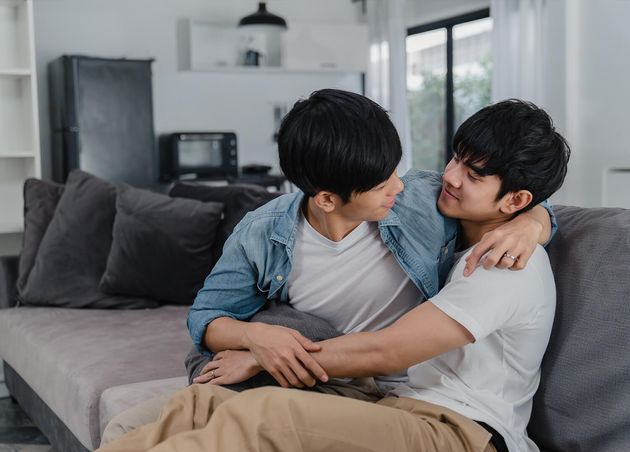 Young Asian Gay Couple Hug Kiss Home Attractive Asian Lgbtq Pride Men Happy Relax Spend Romantic Time Together while Lying Sofa Living Room
