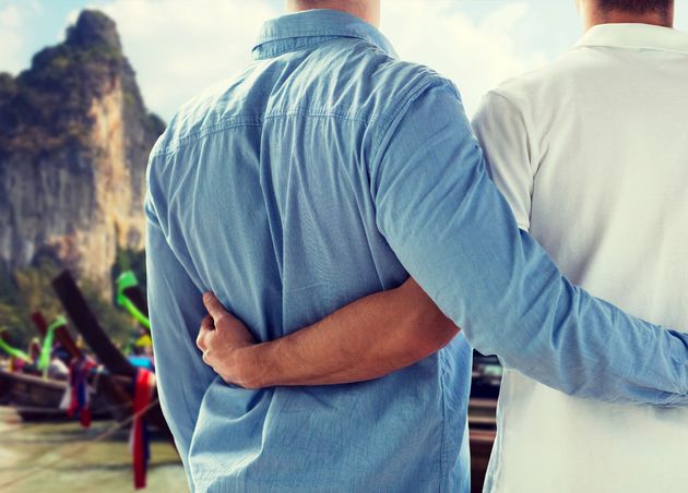 People Homosexuality Travel Love Concept Close up Happy Male Gay Couple Hugging from Back Thailand Beach Background