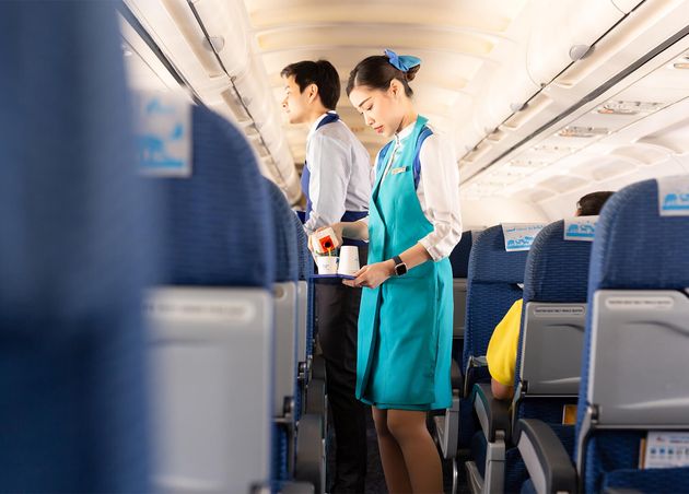 Bangkok Airways Flight Attendant Serve Food Passengers Board