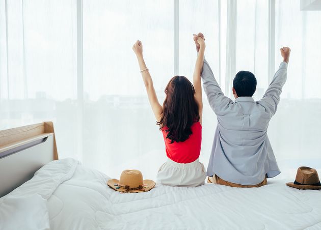 Couple Tourists Happy Holiday Summer Vacation Portrait Back View Young Asian Man Woman Raising Hands with Happy Joyful White Bed near Curtain Window Hotel Room