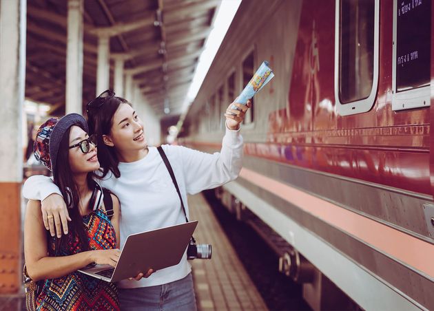 Two Women Are Happy while Traveling Train Station Tourism Concept
