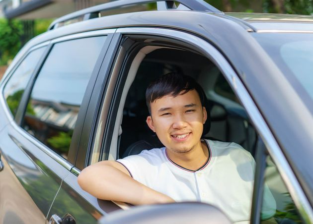 Asian Happy Young Handsome Man Driving Car Front Seat with Smile Prepare Journey with His Car