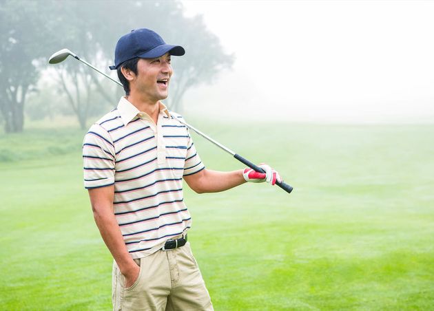 Smiling Golfer Standing Holding His Club