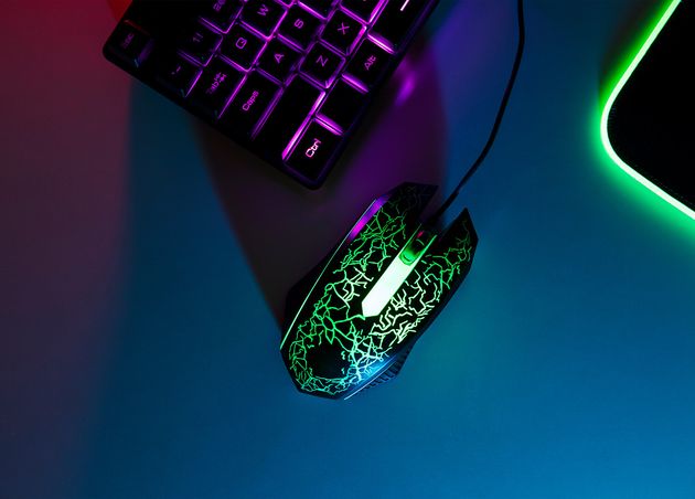 View Neon Illuminated Gaming Desk Setup with Keyboard