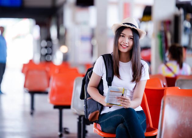 Beautiful Asian Woman Smiling with Map Bag Bus Station