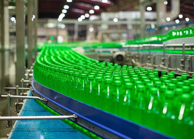 Beverage Factory Interior Conveyor Flowing with Bottles Juice Green