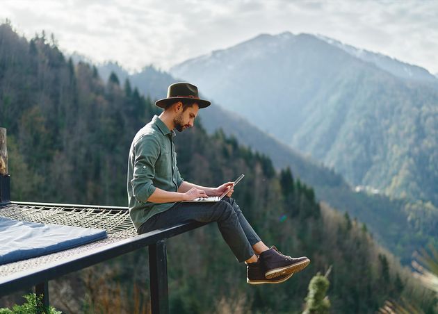 Young Man Freelancer Traveler Wearing Hat Anywhere Working Online Using Laptop Enjoying Mountains View