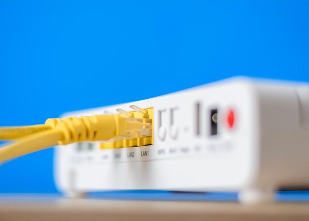 Wireless Internet Router with Connecting Cables Blue Background