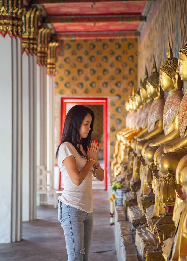 Asian Woman White T Shirt Pay Respect Buddha Statue Buddhist Temple while Traveling Wat Arun Temple Thailand