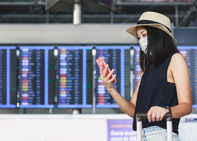 New Normal Traveler Asian Woman with Mask Luggage Using Mobile Phone Terminal Airport Thailand