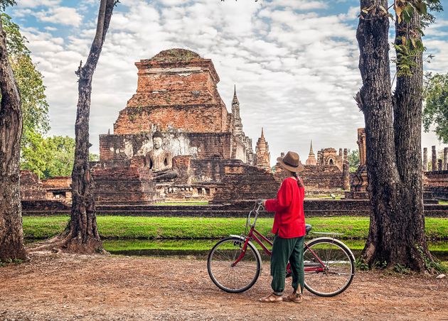Woman with Bicycle near Temple Thailand