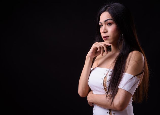 Young Beautiful Asian Transgender Woman against Black