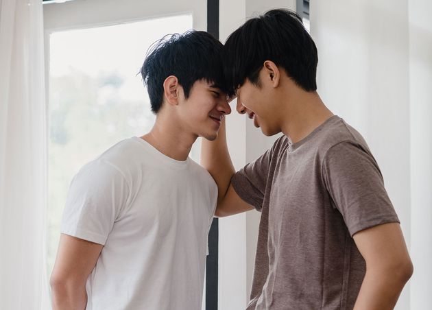Asian Gay Couple Standing Hugging near Window Home Young Asian Lgbtq Men Kissing Happy Relax Rest Together Spend Romantic Time Living Room Modern House Morning