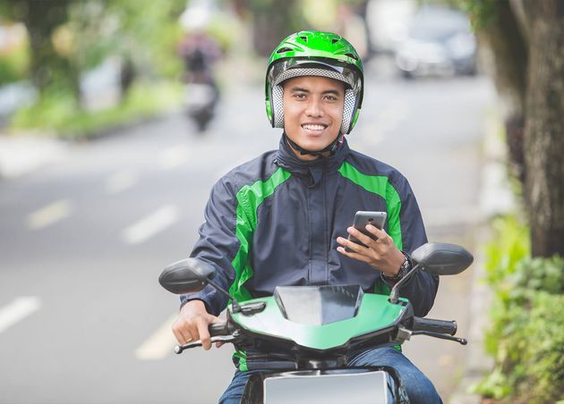 Motorcycle Taxi Driver Taking Order Via Mobile Phone Online App