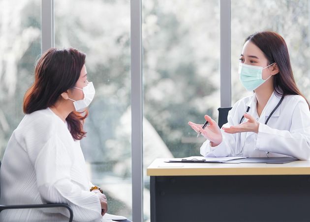 Asian Elder Female Consults with Professional Doctor about Her Symptom Examination Room Hospital