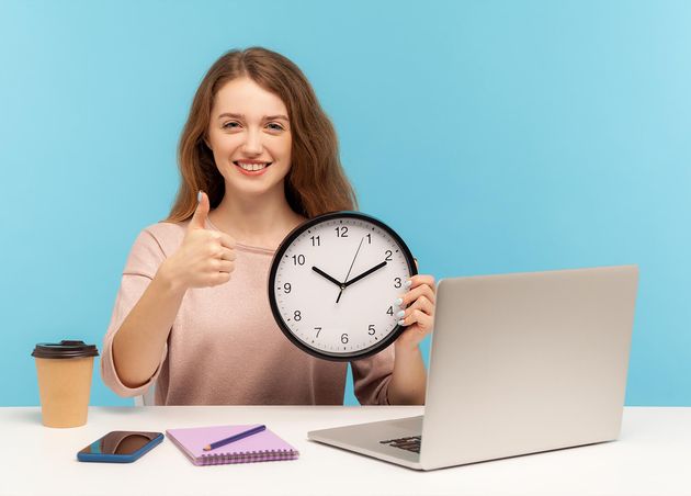 Good Job Time Work Positive Happy Woman Satisfied Office Employee Sitting Workplace Holding Big Clock Showing Thumbs up like Gesture Indoor Studio Shot Isolated Blue Background