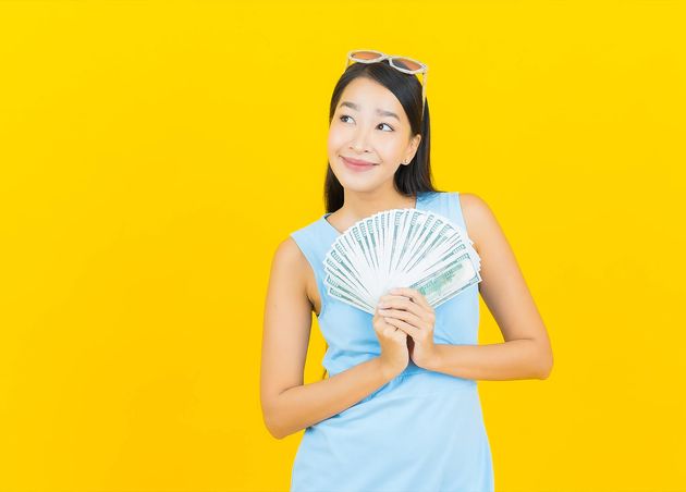 Portrait Beautiful Young Asian Woman Smile with Lot Cash Money Yellow Color Wall