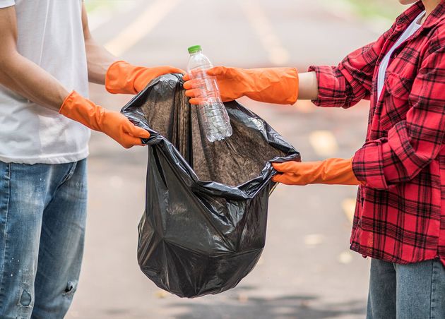Men Women Help Each Other Collect Garbage