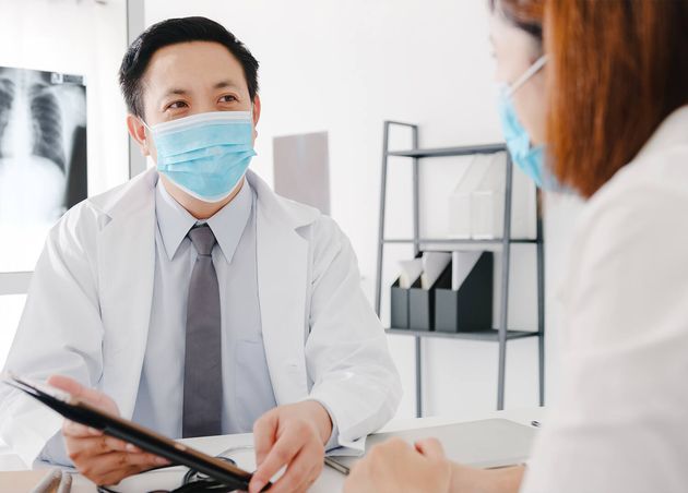 Serious Asia Male Doctor Wear Protective Mask Using Tablet Is Delivering Great News Talk Discuss Results
