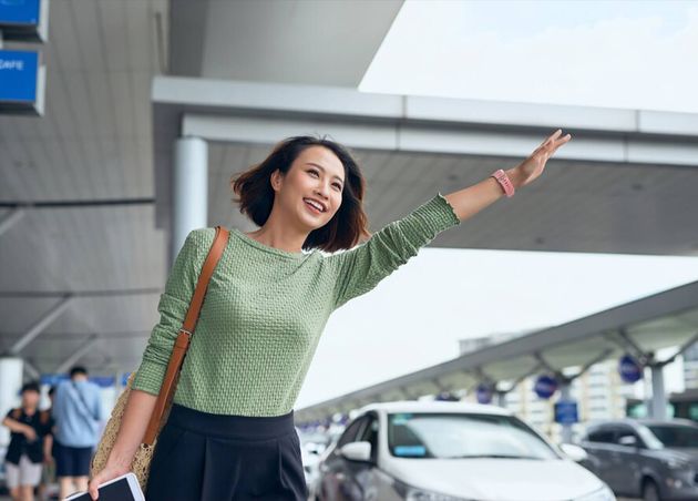 Young Asian Woman See Her Car that Her Booked Via Ride Hailing App Are Waving It Down