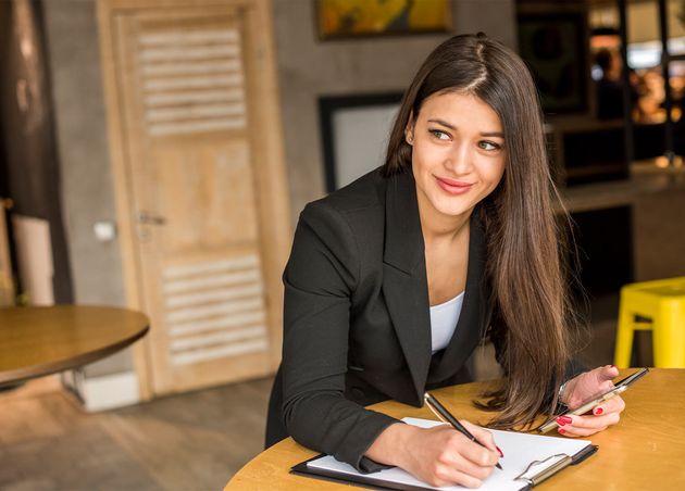 Brunette Businesswoman Writing Document