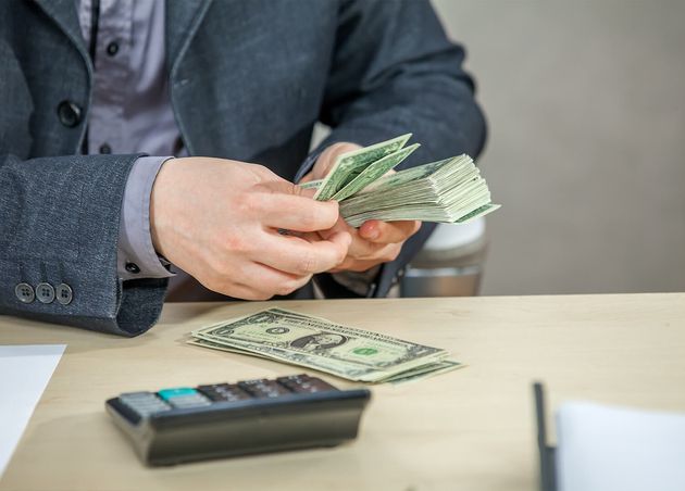 Young Businessman Working from His Office Counting Cash Money