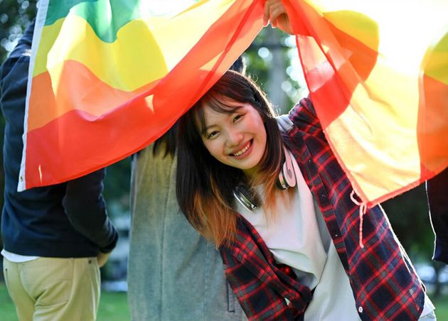 Beautiful Asian Female College Student Holding Lgbt Rainbow Flag with Her Friends Unity Minority