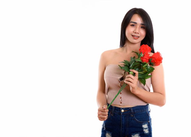 Young Happy Asian Transgender Woman Smiling while Holding Roses