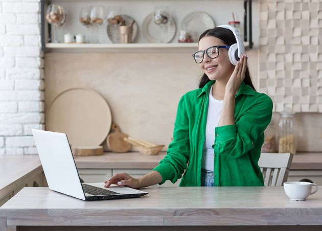 Young Beautiful Woman Sitting Headphones Home Kitchen Table Using Laptop Watch Online