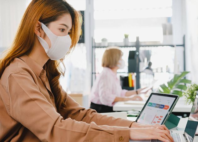 Asia Businesswoman Entrepreneur Wearing Medical Face Mask Social Distancing New Normal Situation Virus Prevention while Using Laptop Back Work Office