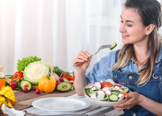 Young Happy Woman Eating Salad with Organic Vegetables Table Light Background Denim Clothes Concept Healthy Home Made Food