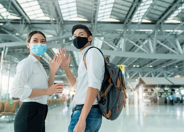 Two Attractive Asian Businessman Businesswoman Wear Face Mask Protection Hand Gesture Wave Greeting Goodbye Social Distancing Departure Airport Terminal