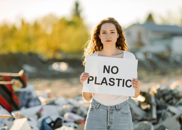 Young Woman Holds Poster Inscription No Plastic Showing Sign Protesting against Plastic Pollution
