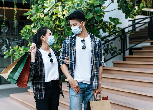Young Couple Protection Mask Holding Multiple Paper Shopping Bag