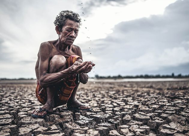 Elderly Man Sitting Touch with Rain Dry Season Global Warming Selection Focus
