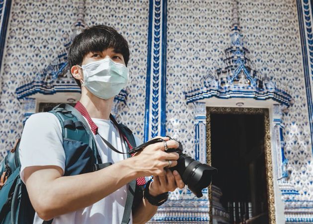 New Normal Travel Concept Happy Traveler Asian Man with Mask Camera