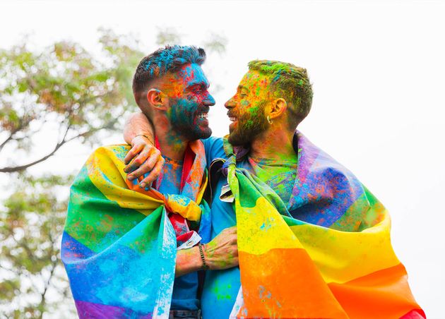 Gay Couple with Painted Faces Rejoicing Hugging