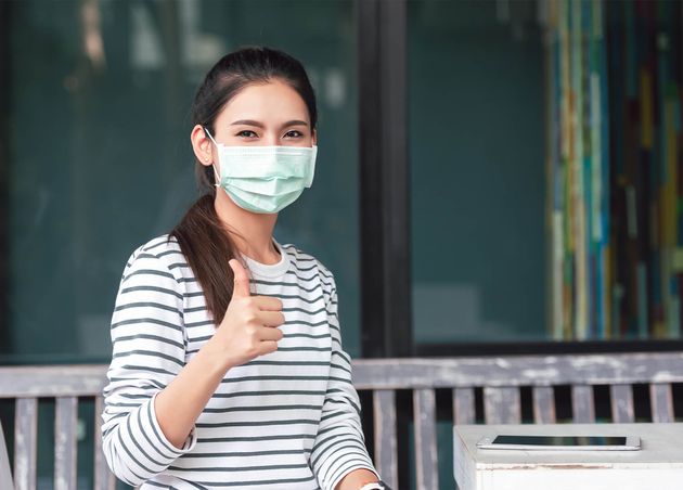 Social Distancing Asian Young Woman Wearing Medical Face Mask Showing Thumbs up New Normal Healthcare Concept