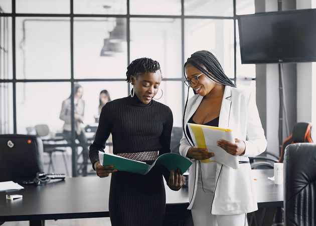 Business Women Talking near Desk during Coffee Break Hallway Big Corporation