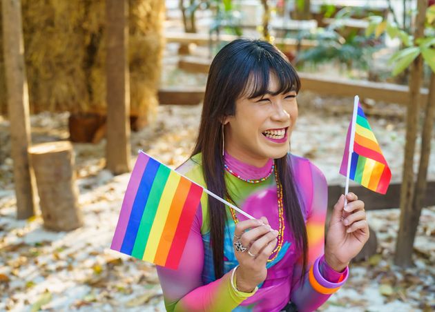 Gender Spectrum Smiling Happy Thai Transgender Asian Woman with Rainbow Flag