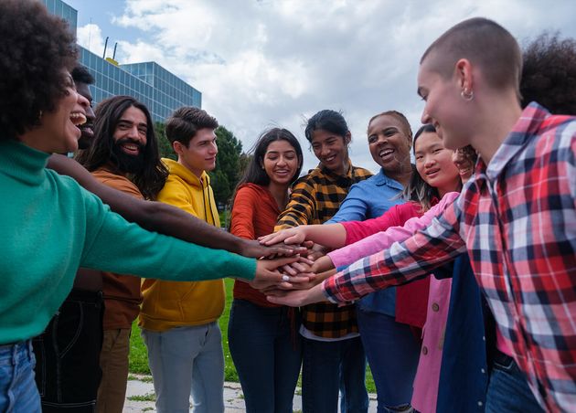 Group Ethnically Diverse Young People Joining Hands