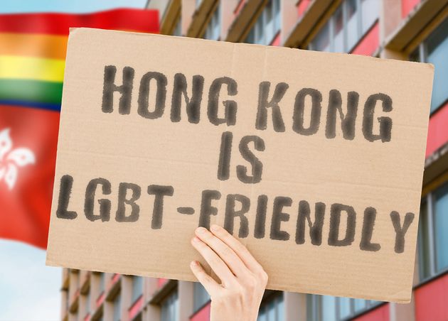 Banner Hongkong ist LGBT-freundlich Mannes Hand mit verschwommener LGBT-Flaggenhintergrund Menschliche Beziehungen Unterschiedliche Diverse Freiheit Sexualität Soziale Probleme Gesellschaft