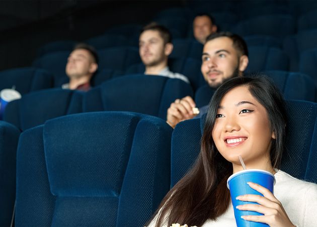 Movies Today Close up Low Angle Shot Beautiful Asian Female Smiling while Watching Movies
